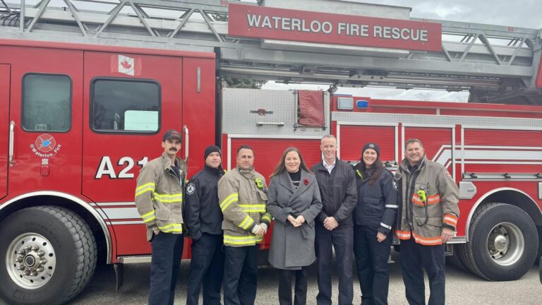 fire truck with fire fighters standing in front