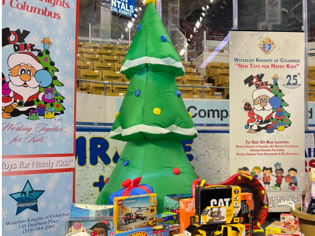 blow up tree at an arena, with toys for kids, and signs about the Toy Drive.