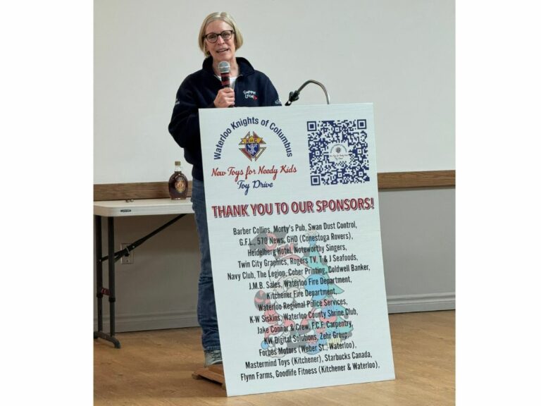 Woman in glasses at podium speaking