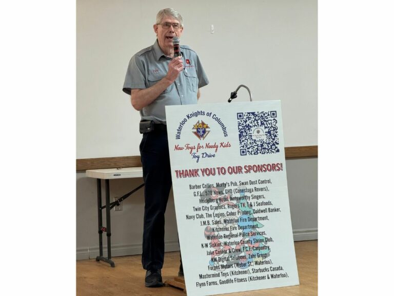 Older man behind a podium speaking